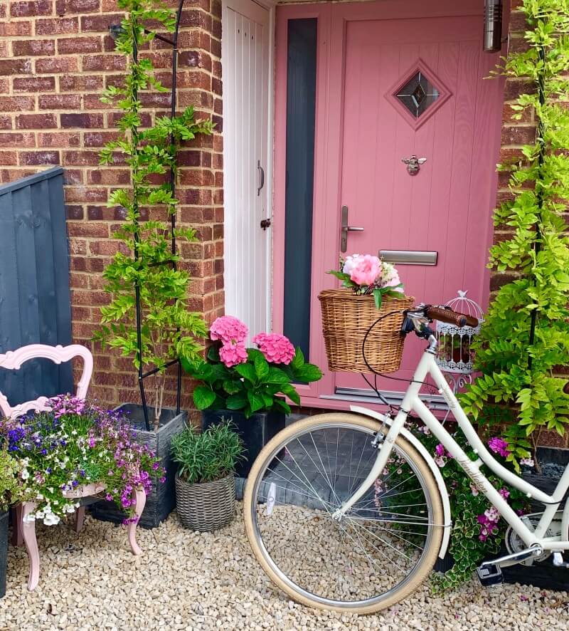 Composite front door in pink with sidelight