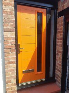 Orange front door installed in Formby