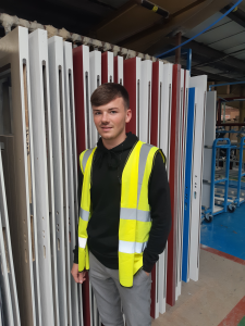 man wearing hi-vis jacket stood next to doors