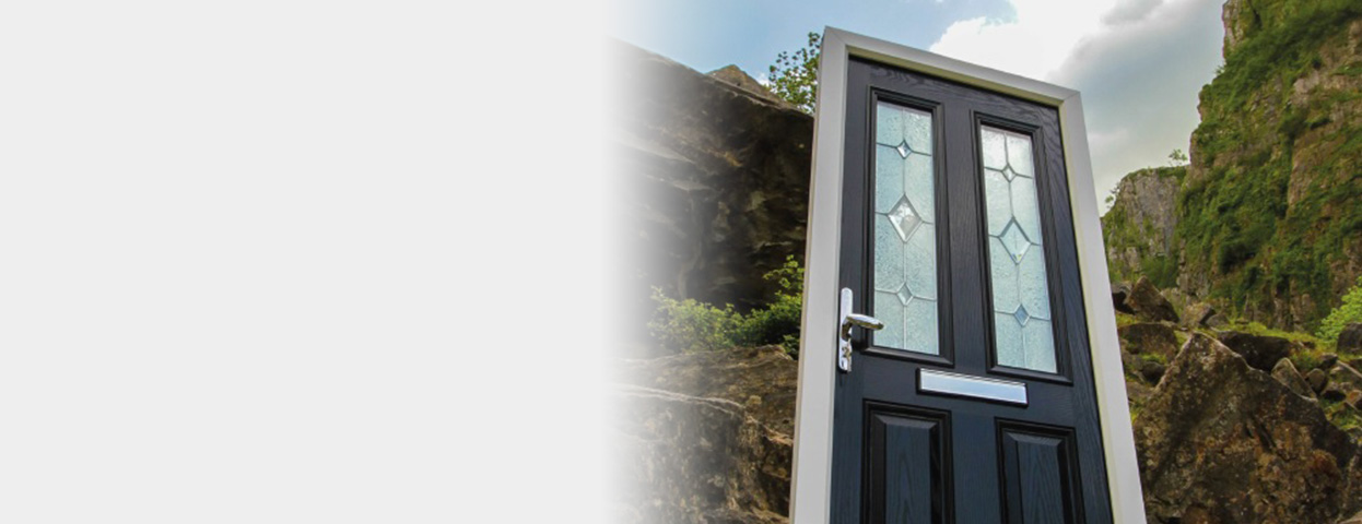 black door and doorframe surrounded by mountainous countryside