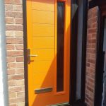 Orange front door installed in Formby